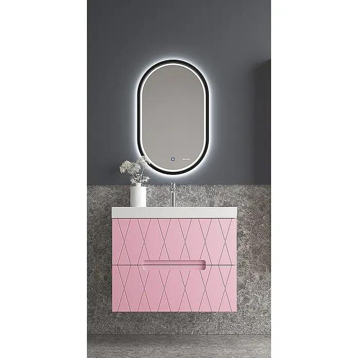 Duplach Mueble bajo de lavabo Nanda - L x An x Al: 45 x 80 x 60 cm, Rosa - Un tocador de baño rosa con lavabo y espejo ovalado con iluminación montado sobre una pared gris.