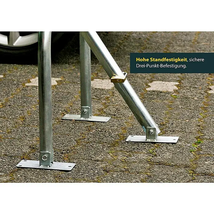 Schellenberg Parkbügel - 440 x 820 x 560 mm, Stahl - Hohe Standfestigkeit: Detailansicht der sicheren Drei-Punkt-Befestigung einer stabilen Fahrradabstellanlage auf Asphalt.