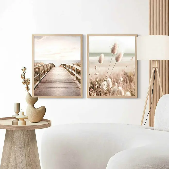 Reinders Holzrahmen - 40 x 50 cm, Buche - Zwei gerahmte Küstenbilder schmücken eine Wand über einem stilvollen Tisch und einem Teil eines Sofas, akzentuiert durch eine Stehlampe.