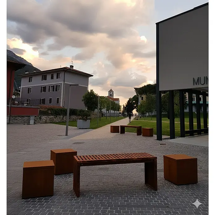 Palatino Sitzauflage Point - L x B x H: 60 x 60 x 6 cm, Rostbraun - Außenansicht mit modernen Metallbänken und Sitzwürfeln auf einem Platz, der zum Verweilen einlädt.