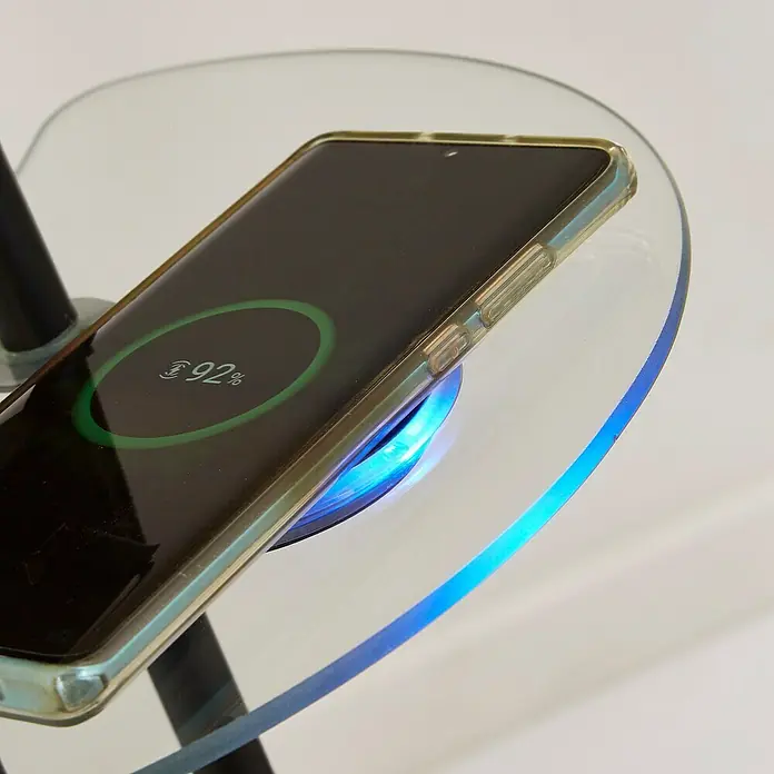 Searchlight LED-Stehleuchte Mother & Child Inkl. Handyladestation - 22,4 W, Höhe: 1,8 cm, Schwarz, Warmweiß - Ein Smartphone mit durchsichtiger Hülle liegt auf einem kabellosen Ladegerät und zeigt einen Ladestand von 92 % an.