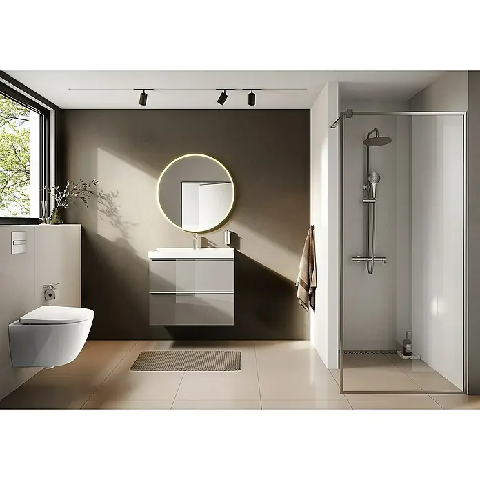 Riva Moon Waschtischunterschrank - B x T x H: 80 x 45,3 x 63,5 cm, Fume - Ein modernes Badezimmer mit einem wandhängenden WC, einem Waschtisch mit Schubladen und einem beleuchteten runden Spiegel. Die Duschkabine ist aus Glas.