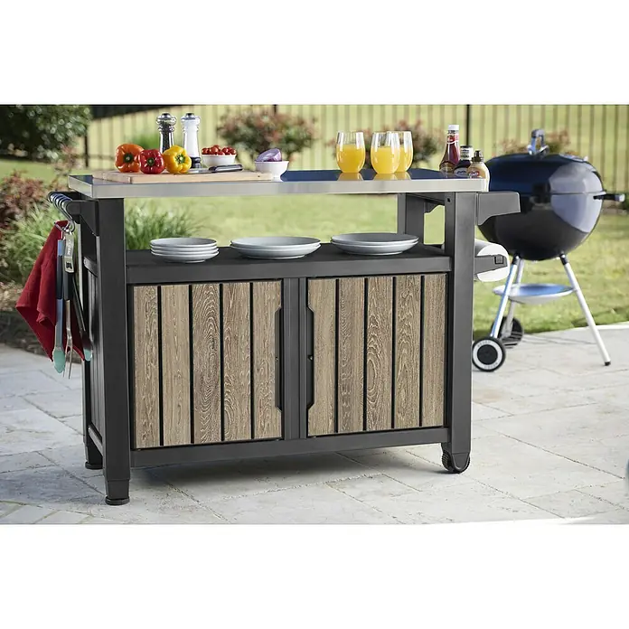 Keter Mesa de servicio Unity XL - L x An: 134 x 52 cm, Marrón/Antracita - Carro de parrilla con armario de madera y encimera de acero inoxidable, ideal para preparar al aire libre.