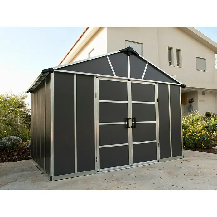 Palram – Canopia Gartenhaus - Außenmaß inkl. Dachüberstand (B x T): 332 x 271 cm, Kunststoff, Grau, Mit Boden - Bild eines geräumigen, modernen Geräteschuppens in Anthrazit mit silbernen Rahmen, ideal für die Gartenaufbewahrung.
