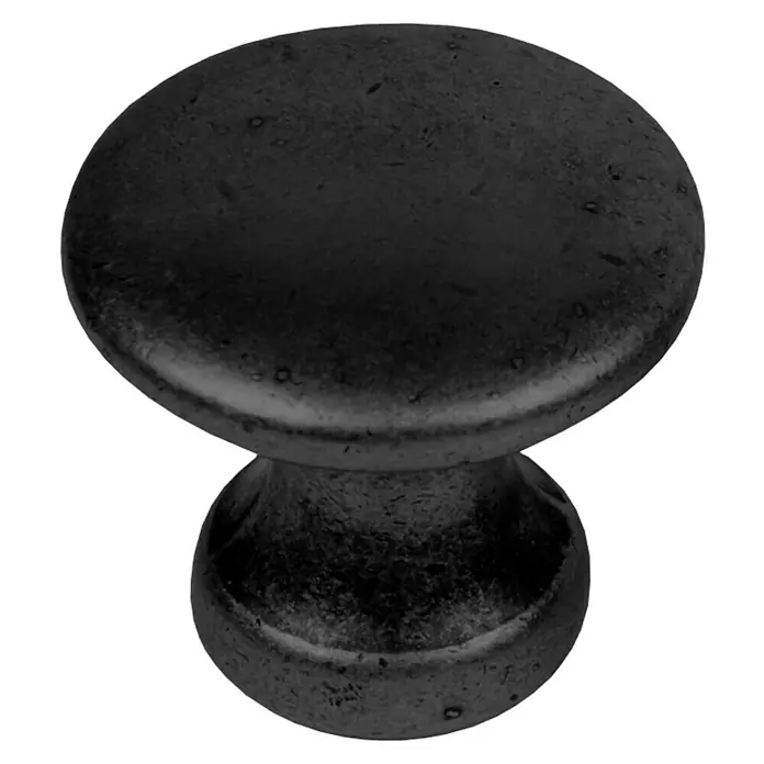Nesu Pomo para muebles 347NE - Ø x Al: 25 x 22 mm, Acero, Negro - Primer plano de un tirador de mueble redondo y negro con un acabado rústico sobre un fondo oscuro.