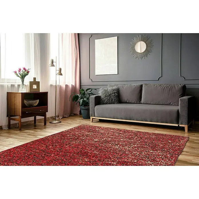 Kayoom Lederteppich Finish - Rot, 230 x 160 cm, 100 % Leder - Ein roter Teppich liegt in einem eleganten Wohnzimmer mit grauem Sofa, Holzschrank und stilvoller Dekoration.