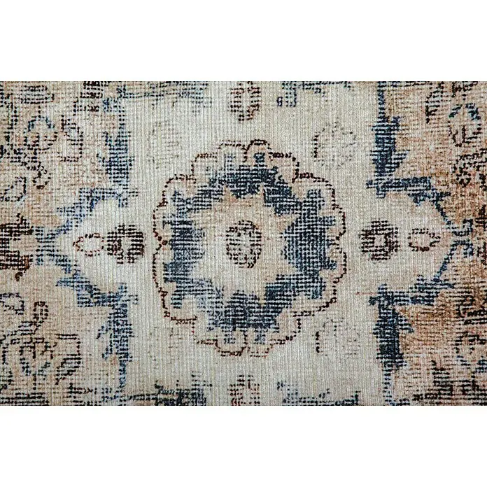 Kayoom Kurzflorteppich Vintage - Creme/Blau, 200 x 140 cm, 100 % Polyacryl - Nahaufnahme eines gemusterten Teppichs mit floralem Medaillon in Blau- und Beigetönen, der eine Vintage-Ästhetik und dekorative Textur zeigt.