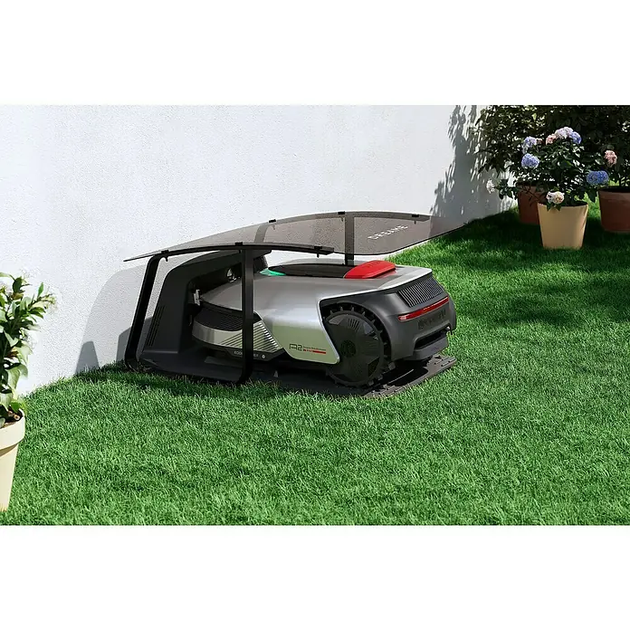 Dreame Mähroboter-Set A2 2000 - 2.000 m², Schnittbreite: 22 cm, Laser-gestützte Navigation, LiDAR - Der Dreametech Robotermäher A2 im modernen Design, parkt unter seinem schützenden Dach auf dem grünen Rasen.