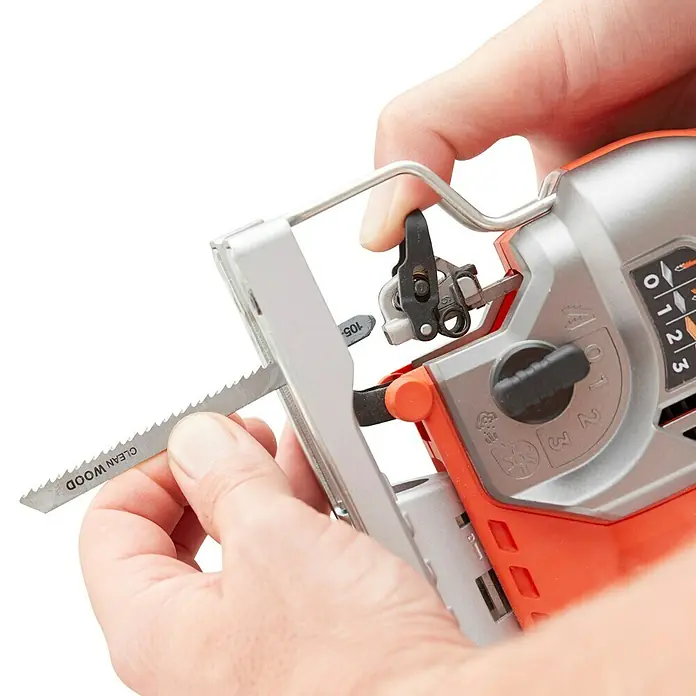 Black+Decker Sierra de calar eléctrica BES610K-QS - 1.000 /min - 3.100 /min, 90 mm - Un primer plano de una sierra de calar mientras una persona inserta una hoja para cortes limpios de madera.