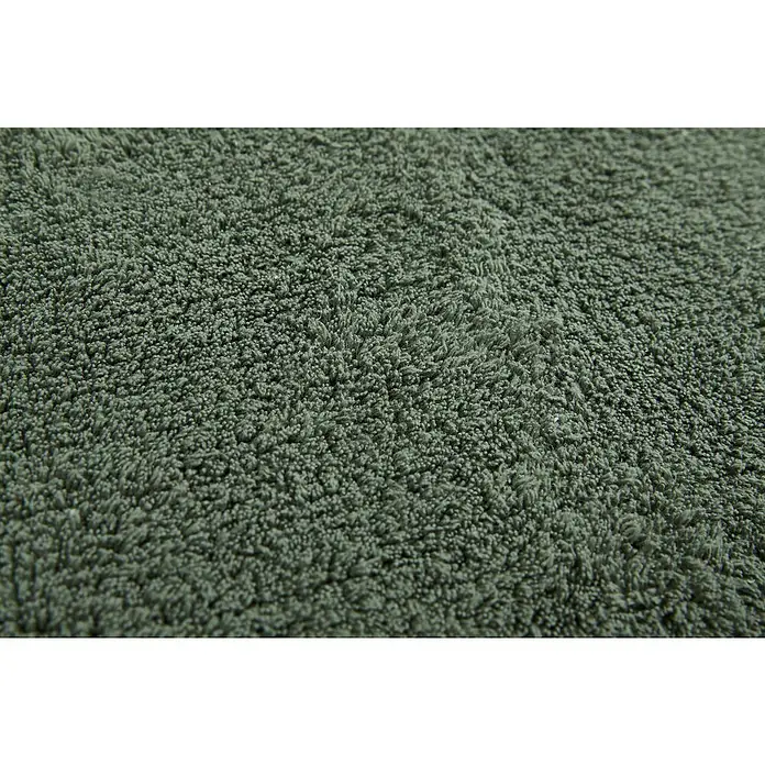 Badteppich Ibiza - 60 x 100 cm, Grün, 100% Baumwolle - Detailaufnahme eines grünen Teppichs mit dichter Textur, ideal für Komfort und Wärme im Zuhause. Die weiche Oberfläche lädt zum Barfußlaufen ein.
