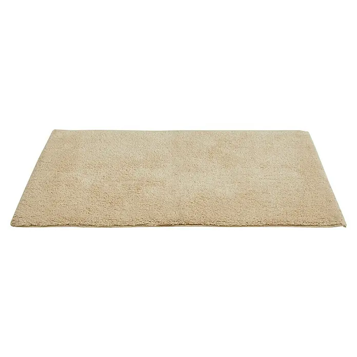 Badteppich Ibiza - 50 x 80 cm, Beige, 100% Baumwolle - Nahaufnahme eines rechteckigen, beigen Shaggy-Teppichs mit dichter Textur, ideal für Komfort und Wärme in jedem Raum.