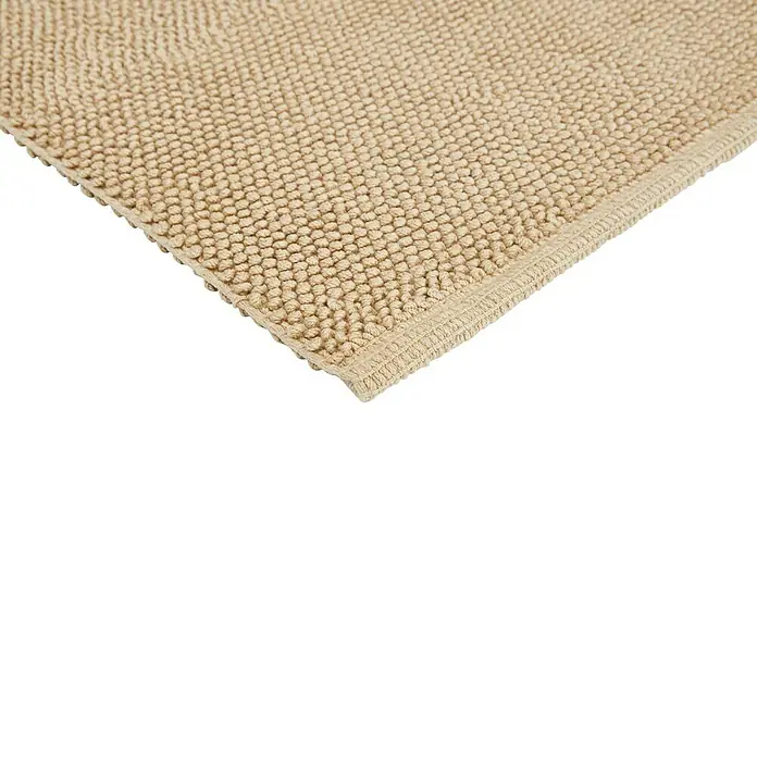 Badteppich Atlanta - 60 x 100 cm, Beige, 100% Baumwolle - Nahaufnahme eines beigen Badteppichs mit Noppenstruktur und sauberer Kante, ideal für Badezimmerböden.