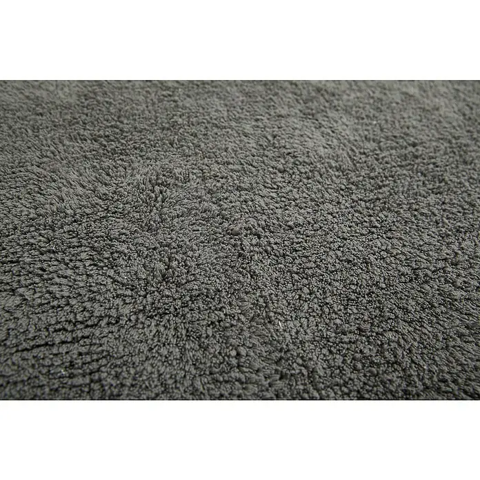 Badteppich Ibiza - 60 x 100 cm, Anthrazit, 100% Baumwolle - Detailaufnahme eines flauschigen grauen Teppichs. Die Textur ist weich und dicht, ideal für zusätzlichen Komfort in jedem Raum.