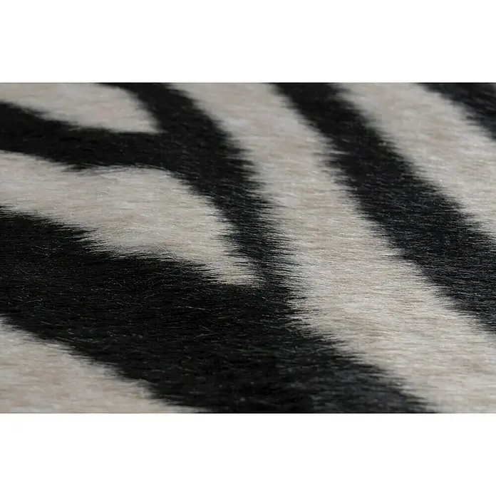 Kunstfell Rodeo - Schwarz/Weiß, 200 x 150 cm, 100 % Polyester, Zebra - Nahaufnahme eines Teppichs mit Zebra-Muster. Das Muster besteht aus abwechselnden schwarzen und weißen Streifen mit leichter Textur.