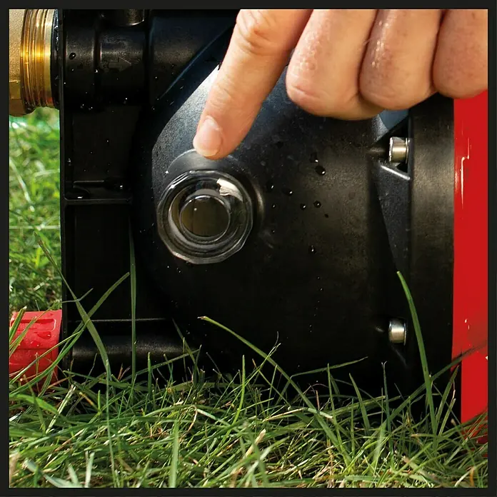 Einhell Gartenpumpe GC-GP 6040 ECO - Leistung: 600 W, Max. Fördermenge: 4.000 l/h - Detailaufnahme einer schwarzen Gartenpumpe mit einem transparenten Sichtfenster, auf das eine Hand deutet, um den Füllstand anzuzeigen.