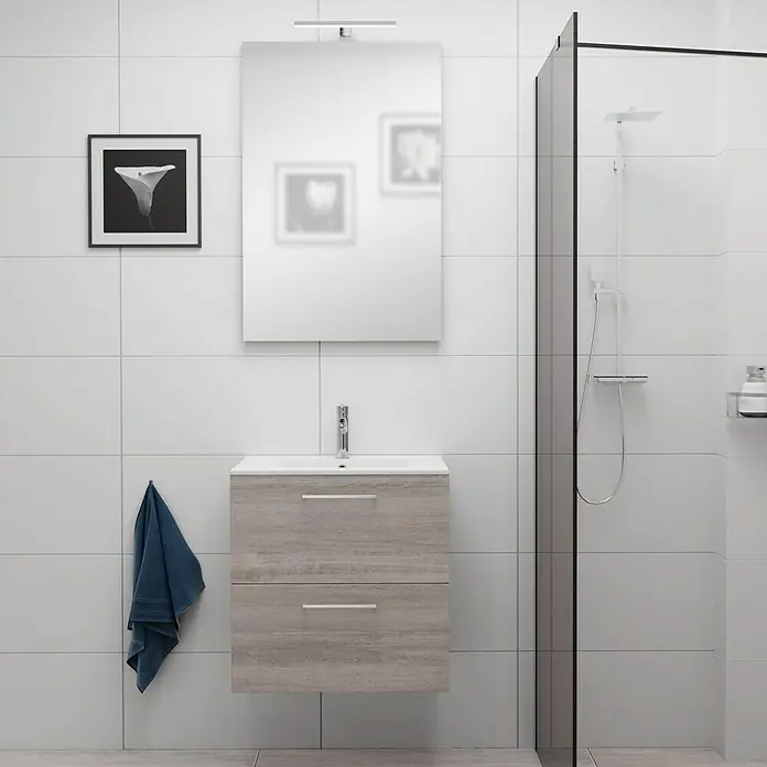 Camargue Espacio Badmöbel-Set E16 - 60 cm, Faro - Badezimmer-Interieur mit einem modernen Waschtisch in Holzoptik, einem Spiegel und einer Dusche mit Glasabtrennung vor weißem Fliesenhintergrund.