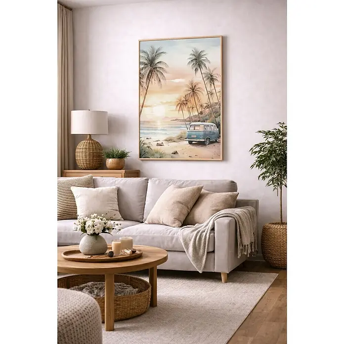 Lienzo Furgo playa - Furgo playa, An x Al: 50 x 70 cm - Un salón con un sofá gris claro, una mesa de centro redonda de madera y un cuadro enmarcado con una escena de playa.
