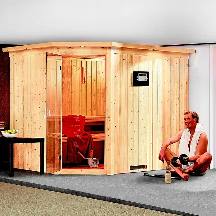 Karibu Elementsauna Malin - Mit 9 kW Ofen mit integrierter Steuerung, Ohne Dachkranz, L x B x H: 231 x 196 x 192 cm - Saunakabine aus Holz mit einem Mann, der Gewichte hebt. Die Sauna verfügt über ein digitales Bedienfeld und eine Glastür.