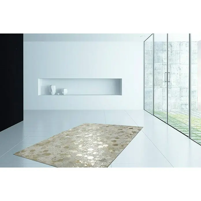 Kayoom Lederteppich Dazzle 200 - Elfenbein/Gold, 170 x 120 cm, 100 % Leder - Ein stilvoller Teppich mit abstraktem Muster liegt in einem modernen, hellen Raum. Der Teppich verleiht dem Raum eine elegante Note und Wärme.