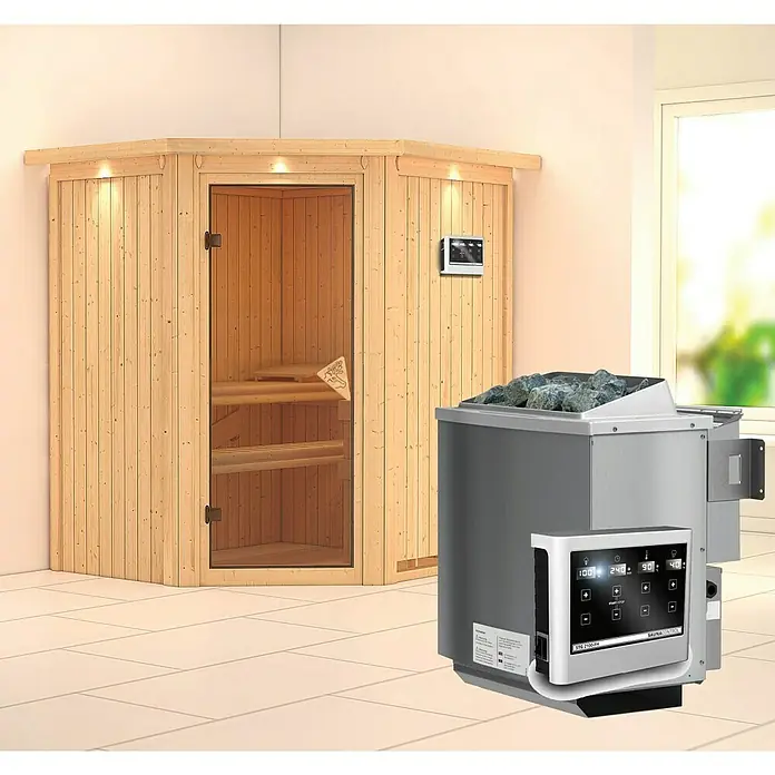 Karibu Elementsauna Taurin - Mit 9 kW Bio-Ofen mit externer Steuerung, Mit Dachkranz und Beleuchtung, L x B x H: 184 x 165 x 192 cm - Saunaofen mit Steinen auf einem hellen Boden, neben einer hellen Holzkabine mit Glastür.