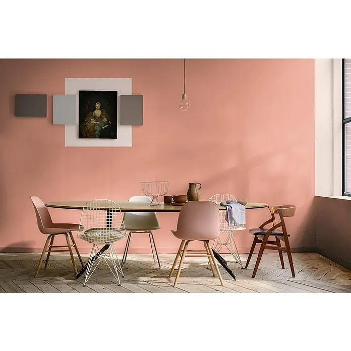 Bruguer Elegance Pintura para paredes - Rojo amapola, Mate, 4 l - Elegante comedor con una mesa ovalada rodeada de sillas estilosas, complementado con una sutil lámpara colgante y arte mural con pintura.
