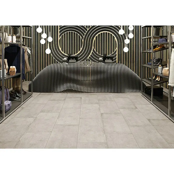 Feinsteinzeugfliese Savanna - 59,7 x 119,7 cm, Desert, Matt - Elegantes Interieur eines Bekleidungsgeschäfts mit stylischer Theke und moderner Beleuchtung, das ein luxuriöses Einkaufserlebnis verspricht.