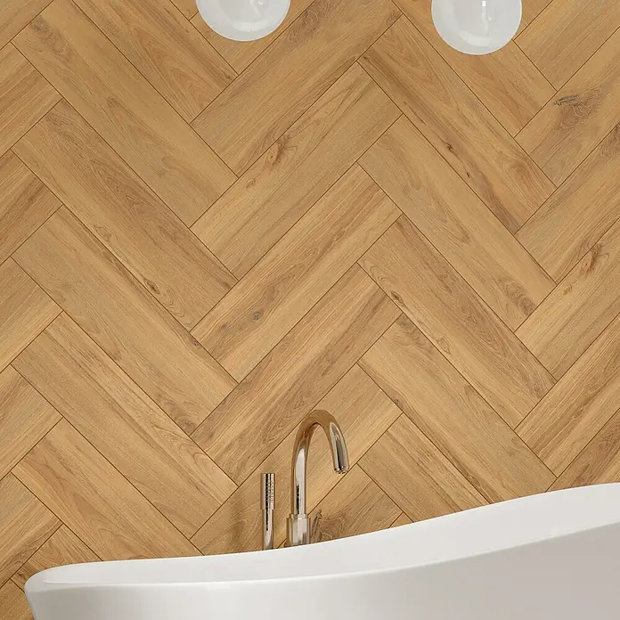 Feinsteinzeugfliese Sealwood - 17,5 x 60 cm, Beige, Matt - Detailaufnahme eines modernen Badezimmers mit einer freistehenden Badewanne und einer stilvollen Holzwand im Fischgrätmuster. Elegantes Design für Ihr Zuhause.