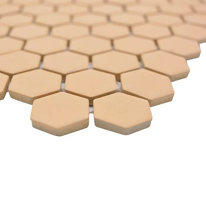Mosaikfliese Hexagon Uni HX AT27 - 26 x 30 cm, Orange, Matt - Nahaufnahme eines Musters aus sechseckigen Mosaikfliesen in einem warmen Beigeton, ideal für Boden- oder Wandbeläge.