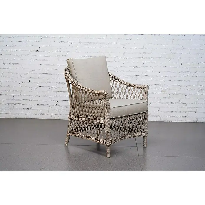 Sunfun Conjunto de muebles Soraya - 4 pzs., Ratán sintético/Aluminio/Poliéster, Beige/Gris - Elegante sillón de ratán con cojines beige sobre una pared de ladrillo blanco. Ideal para relajarse en un ambiente con estilo.