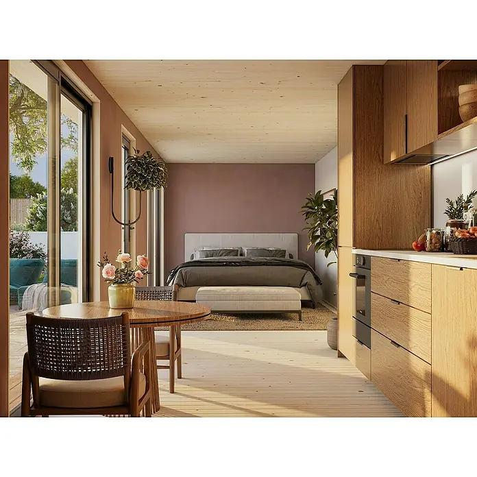 Palmako Gartenhaus Johanna Nordic Plus - Außenmaß inkl. Dachüberstand (B x T): 901 x 339 cm, Holz, Natur unbehandelt - Das Bild zeigt eine gemütliche Inneneinrichtung mit Fokus auf einen runden Holztisch mit Stühlen im Vordergrund.