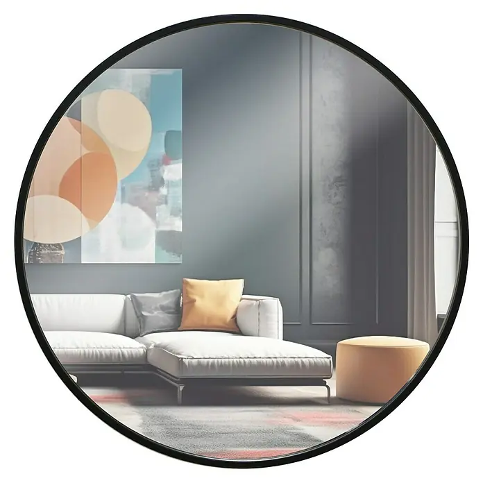 Espejo de pared de hierro - Diámetro: 60 cm, Negro - Un espejo redondo con marco negro refleja un moderno salón con un sofá blanco, un cuadro y un puf color mostaza.