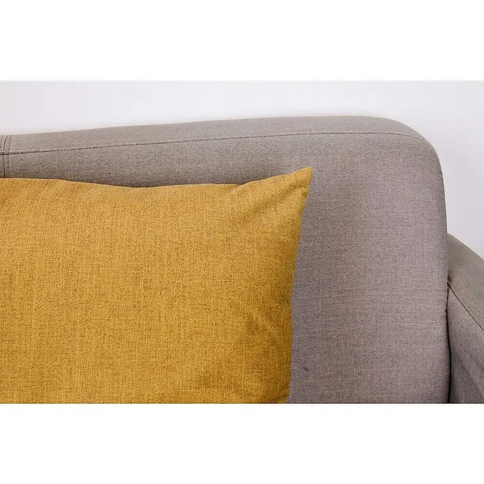 Kissen Finn - Gelb, 45 x 45 cm, 100 % Polyester - Ein gelbes Zierkissen auf einem grauen Sofa. Das Kissen ist quadratisch und hat eine leicht strukturierte Oberfläche, die eine gemütliche Atmosphäre schafft.