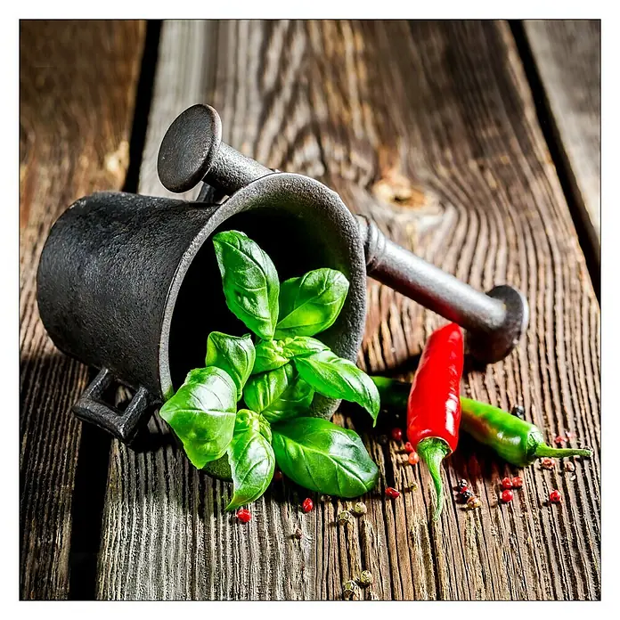 Glasbild - Green Basil In Bowl II, B x H: 20 x 20 cm - Mörser und Stößel aus Gusseisen mit frischem Basilikum und scharfen Chilischoten auf rustikalem Holztisch für kulinarische Genüsse.