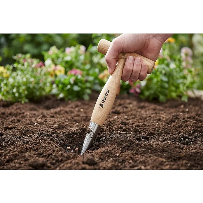 Gardol Pflanzholz - 29,5 cm - Gartenszene mit einem Gardol-Pflanzholz, das in die Erde gesteckt wird, um ein Loch für das Pflanzen zu schaffen. Praktisches Werkzeug für Gärtner.