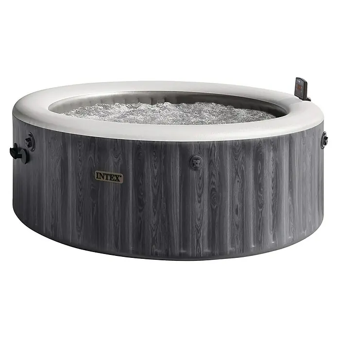 Intex Pure Spa Hidromasaje móvil Greenwood - Ø x Al: 196 x 71 cm, Gris/Blanco, 795 l - Una bañera de hidromasaje Intex redonda y gris con un borde blanco y panel de control. El agua en el interior es burbujeante e invita a la relajación.