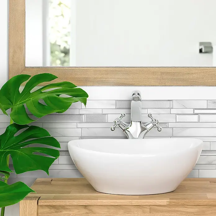 Smart Tiles Selbstklebemosaik Milano - 29,33 x 24,45 cm, Carrera, Matt - Nahaufnahme eines modernen Badezimmers mit einem stilvollen Waschbecken und dekorativen Akzenten, die eine elegante und entspannende Atmosphäre schaffen.