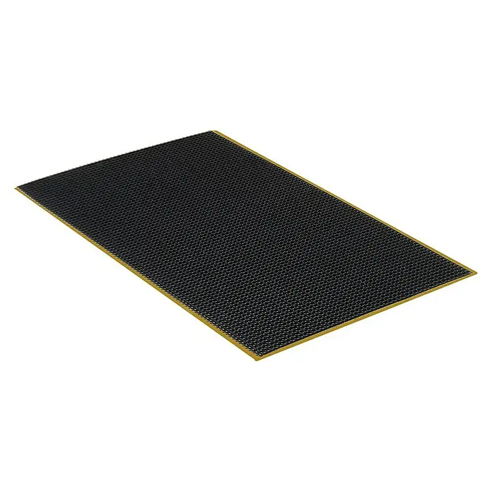 Montagepads für Akustikpaneele - L x B x S: 70 x 40 x 1 mm, Schwarz - Nahaufnahme eines schwarzen Bienenwachsfundamentes mit gelbem Rand für Bienenstöcke, das eine Struktur mit kleinen Zellen zeigt.