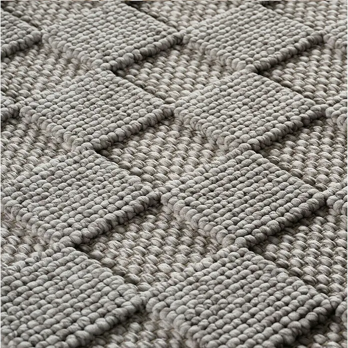 Flachgewebeteppich Helix 2203 - Silber, Durchmesser: 200 cm, 100 % Polyester - Nahaufnahme eines grauen Teppichs mit einem quadratischen Noppenmuster, das eine interessante Textur und ein gemütliches Ambiente erzeugt.