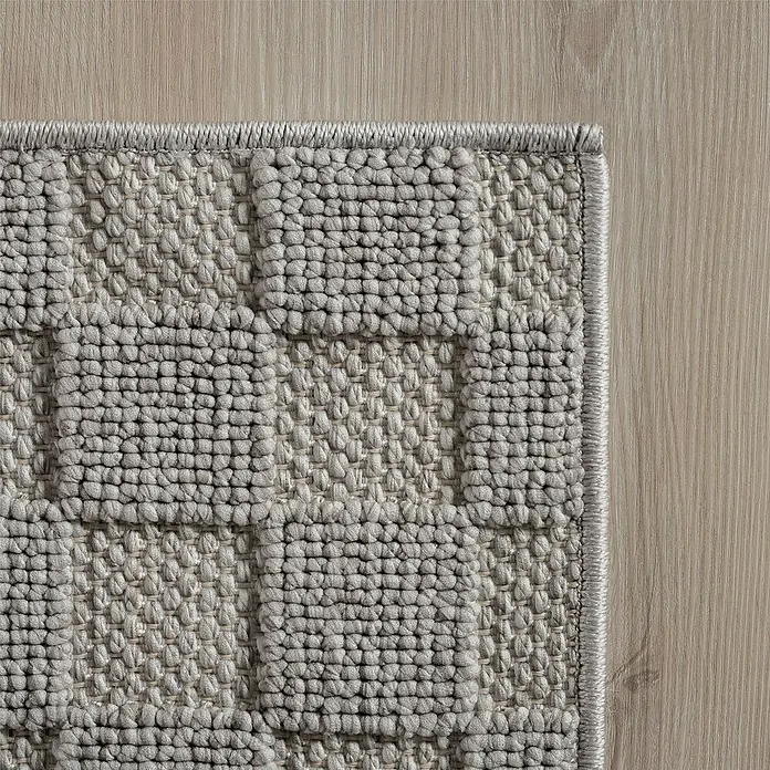 Flachgewebeteppich Helix 2203 - Silber, Durchmesser: 200 cm, 100 % Polyester - Detailaufnahme eines beigen Teppichs mit geometrischem Muster und sauberer Kante auf einem hellen Holzboden. Hochwertige Textur.