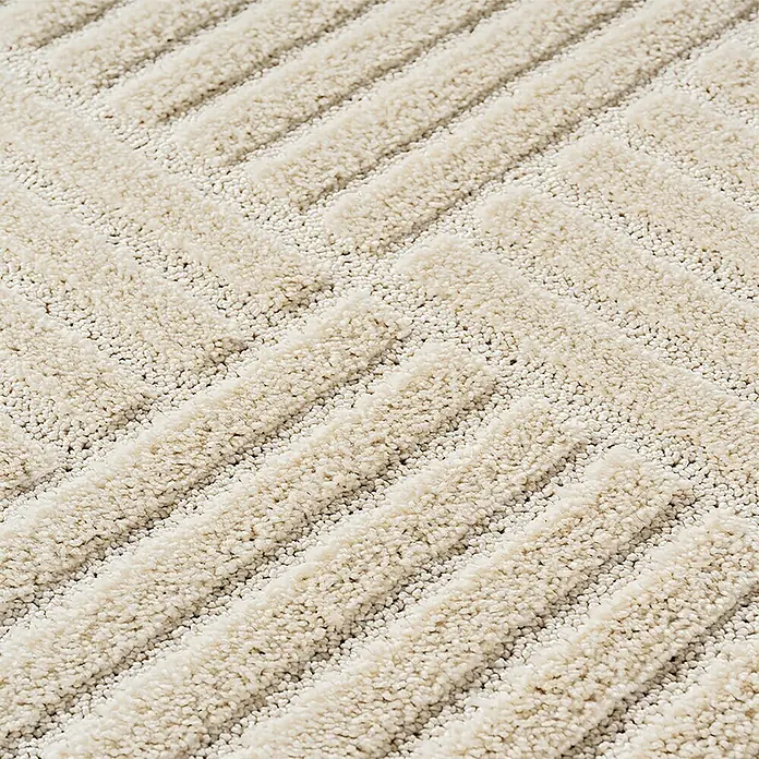 Kurzflorteppich Art 1123 - Creme, Durchmesser: 120 cm, 100 % Polypropylen - Nahaufnahme eines hellbeigen strukturierten Teppichs mit erhabenem Zickzackmuster.