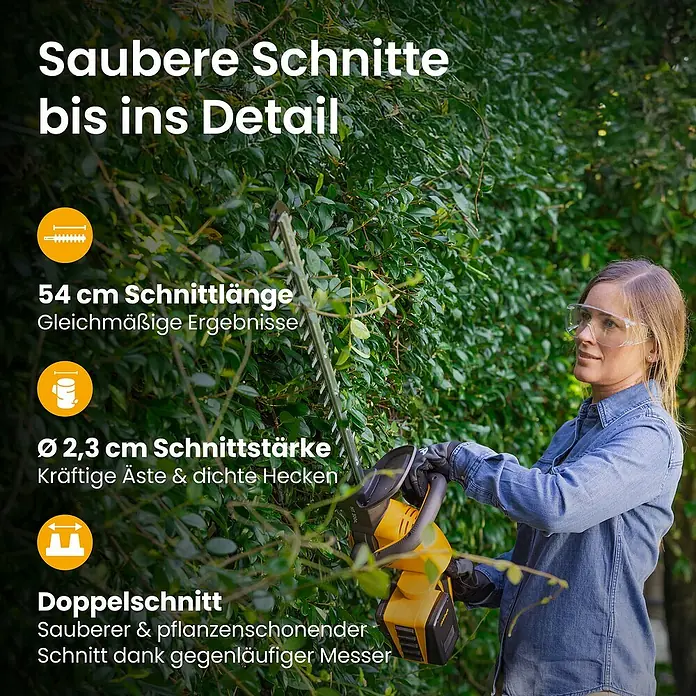 Stiga Akku-Heckenschere HT 300E - 2 Akkus, Schnittlänge: 54 cm - Frau in Jeanshemd und Schutzbrille trimmt eine grüne Hecke mit einem gelb-schwarzen Heckenschere.