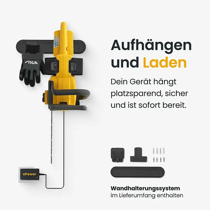 Stiga Akku-Kettensäge CS300E - 20 V, 4 Ah, Li-Ionen, 2 Akkus, Schwertlänge: 30 cm - Eine gelbe Kettensäge hängt an einer Wandhalterung und lädt. Graue Handschuhe und Wandhalterungskomponenten sind ebenfalls sichtbar.