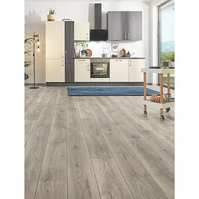 LOGOCLIC Aquaprotect Smart Silent Laminat - Lombok Oak, Landhausdiele, 1.288 x 195 x 7 mm - Hellgrauer Laminatboden in Holzoptik, verlegt in einer modernen Küche.