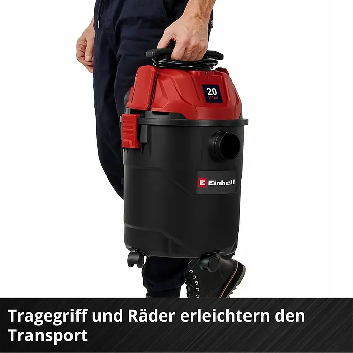 Einhell Nass-Trockensauger TC-VC 2045 - 850 W, 20 l - Eine Person trägt einen rot-schwarzen Einhell 20-Liter Nass-Trockensauger, der seinen Tragegriff und Rollen für einfachen Transport zeigt.