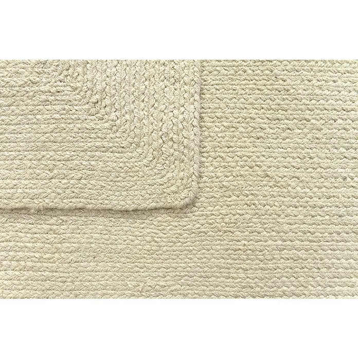 Alfombra exterior In/Out Ebro - Crema, 110 x 60 cm, 100% Polietileno - Alfombra trenzada beige claro con textura tejida y una esquina visible.