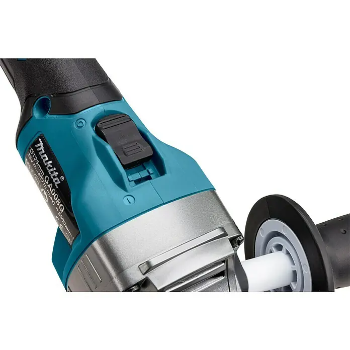 Makita XGT 40V max. Akku-Winkelschleifer GA008GM201 - 2 Akkus, 4 Ah, Durchmesser Scheibe: 125 mm - Nahaufnahme eines tealfarbenen und schwarzen Makita Winkelschleifers mit Metallgehäuse und schwarzem Schalter. Ein schwarzer Seitenhandgriff ist teilweise sichtbar.
