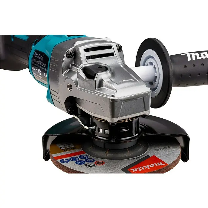 Makita XGT 40V max. Akku-Winkelschleifer GA008GM201 - 2 Akkus, 4 Ah, Durchmesser Scheibe: 125 mm - Türkise und silberne Makita Winkelschleifer mit schwarzem Schutz und brauner Trennscheibe.