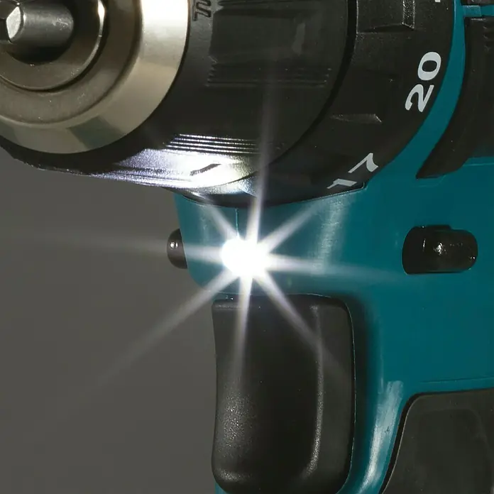 Makita CXT 12V max. Akku-Schlagbohrschrauber HP333DZ - 12 V, Ohne Akku, 30 Nm, Ohne Akku und Zubehör - Türkisfarbene und schwarze Akku-Bohrmaschine mit eingeschalteter LED-Leuchte.
