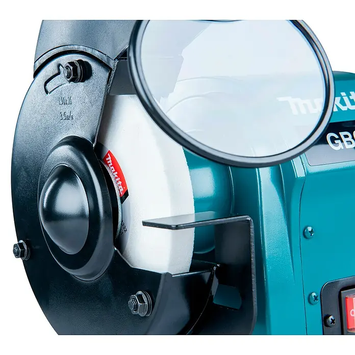 Makita Elektro-Doppelschleifer GB602 - 250 W, 2.850 U/min - Türkiser Makita Doppelschleifer mit weißer Schleifscheibe, schwarzem Schutzgehäuse, klarem Augenschutz und Werkstückauflage.
