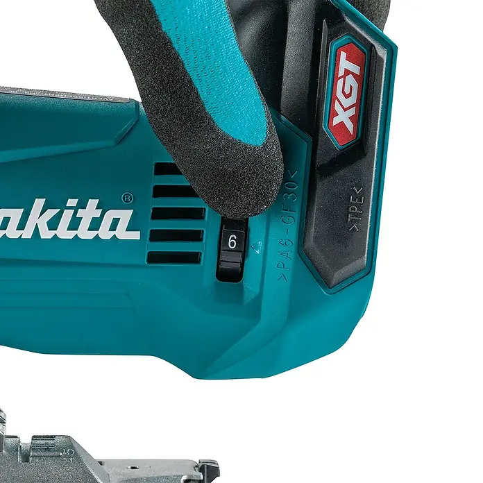 Makita XGT 40V max. Akku-Pendelhubstichsäge JV002GZ - 40 V, Ohne Akku, 0 /min - 3.500 /min - Nahaufnahme eines türkisfarbenen Makita Elektrowerkzeugs mit XGT-Akku und einer Hand, die einen Drehregler auf '6' stellt.
